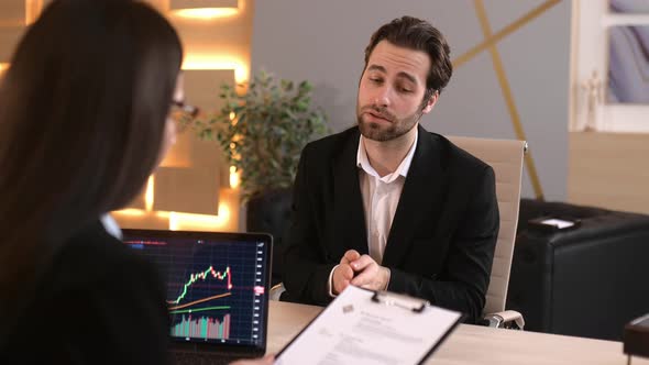 Upset Young Woman in Black Business Suit and Glasses Sitting in the Street with Cardboard Job Wanted alt