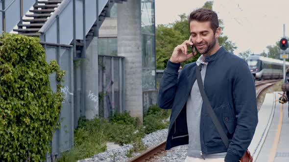 Handsome Guy On Phone And Waiting For Train