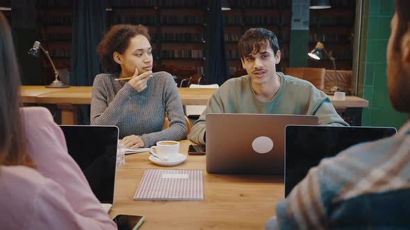 Young Man Professional Expert Consult Multiethnic Teammates on Briefing alt