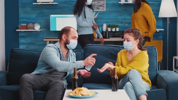 Mixed Races Friends with Medical Masks Disinfecting Hands alt