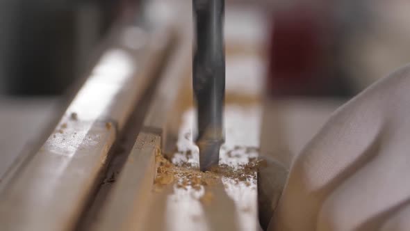 Drilling Holes in the Board with a Drilling Machine