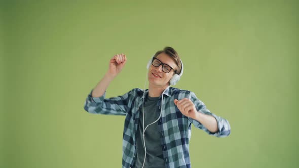 Portrait of Modern Guy Listening To Music in Headphones and Dancing Having Fun alt