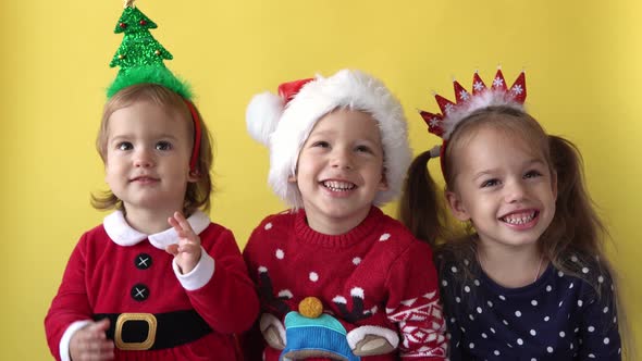 Emotion Cute Happy Cheerful 3 Siblings Friends Baby Girl And Boy in Santa Suit Smiling Laughing alt