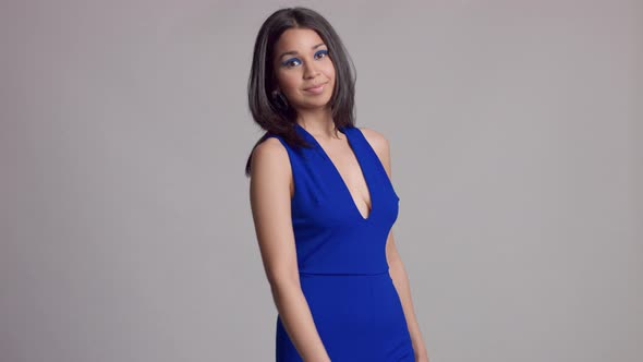 Mixed Race Young Woman Withbright Blue Makeup in Studio Shoot in Electric Blue Dress
