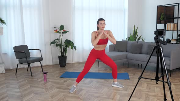 Fit Woman Fitness Trainer Blogger Doing Warmup Exercise Workout at Modern Home alt