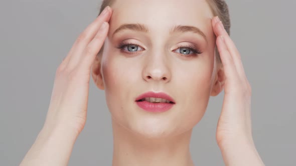Studio portrait of young, beautiful and natural woman over grey background. alt
