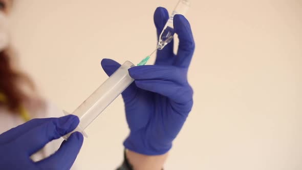 Woman Filling the Syringe with Medication.