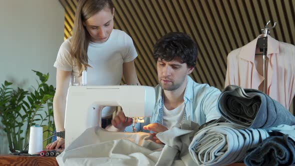 Teacher Helping a Fashion Student Learning to Use the Sewing Machine alt