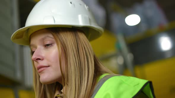 Closeup Face of Young Beautiful Woman in Hard Hat Standing on the Left Looking Away with Green Eyes alt