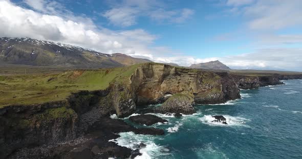 Lava cliffs at Snaefellsnes, Iceland, Snaefellsjokull volcano in the back alt