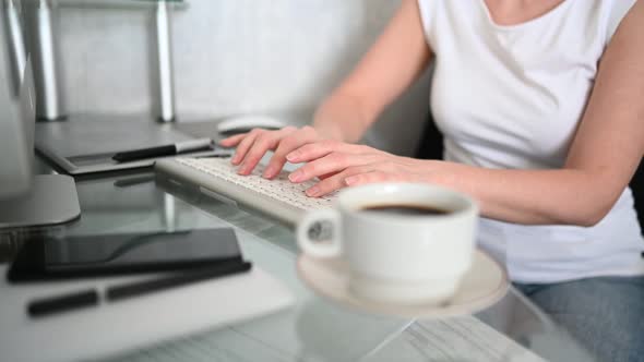 Technology Concept Close Up Hands of Unrecognizable Woman Sitting in Front of Computer with Coffee