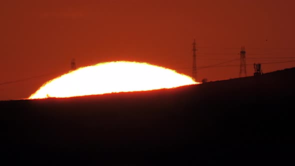 Sunrise Behind City's Electric Poles and Cables With Mega Telephoto Zoom Under Heat Radiation alt