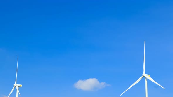 Time-lapse of Wind Turbine in wind farm with cloud sky