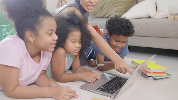 Happiness African family with mother and children using laptop computer watching video media online. alt