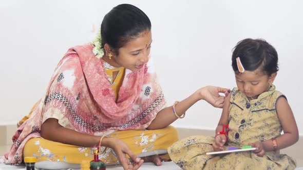 Medium Closeup shot of Indian Mother and Daughter playing with toys, Mother teaching a child how to alt