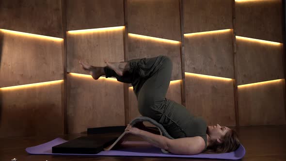 Curing of Osteochondrosis at Home Woman Is Training at Home Lifting Legs Up alt