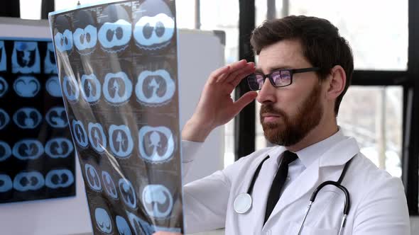 Smart Concentrated Caucasian Doctor in a Medical Uniform a Pulmonologist a Therapist Stands in alt