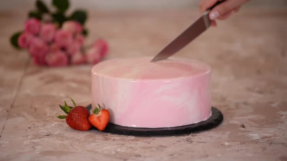 Cutting a Strawberry Mousse Cake with Pink Mirror Glaze