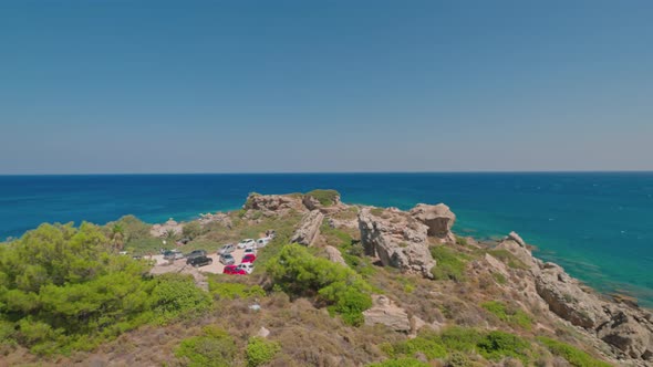 Beautiful view of rocky coast of Mediterranean Sea with equipped beaches and parking for cars. alt