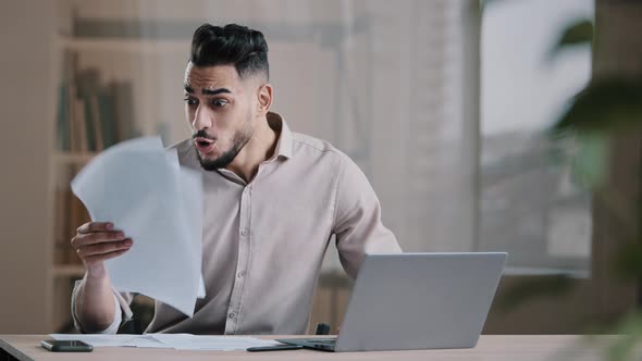 Shocked Happy Successful Businessman Arabic Guy Check Documents Receive Approval Bank Credit alt