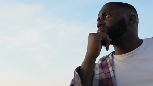 African-American Man Contemplating About Life Against Deep Blue Sky, Close-Up