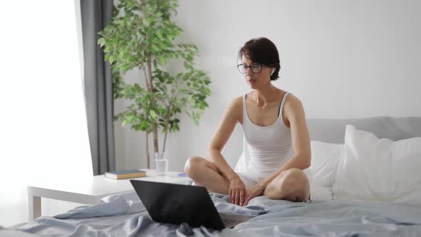 Woman in Bed with Laptop