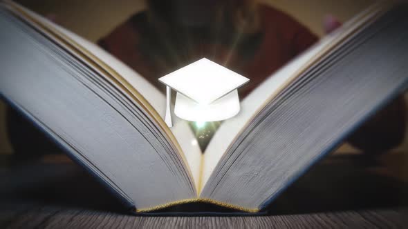 Graduation cap appears from a book when it is opened. Studying, learning, education system, universi alt
