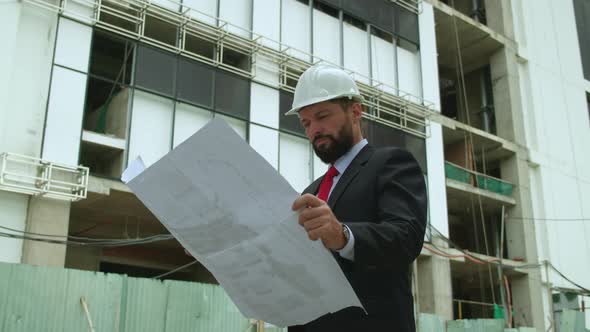 An Engineer Developer at a Construction Site Checks on the Drawings at What Stage the Construction alt