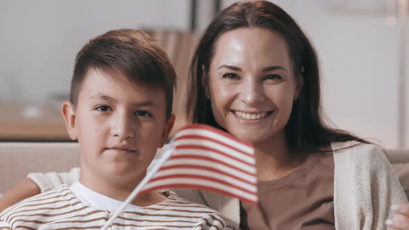 Patriotic Mother and Son Waving American Flags alt
