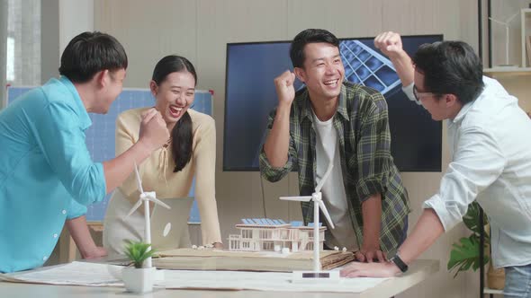 Asian Engineers Group Celebrating Finish Assembling The Model Of Small Houses With Solar Panel alt