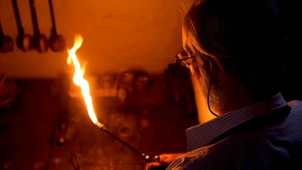 Goldsmith holding welding torch in workshop 4k alt
