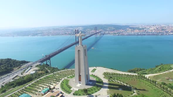 Aerial view of Sanctuary of Christ the King overlooking Lisbon and 25 de Abril Bridge connecting Lis alt