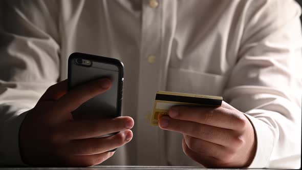 Man online banking using smartphone shopping online with credit card