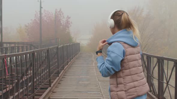 Slowmo of Woman Jogging on Foggy Morning alt