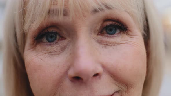 Closeup Elderly Female Face Blue Eyes Mature Smiling Woman Satisfied with Ophthalmic Procedure alt