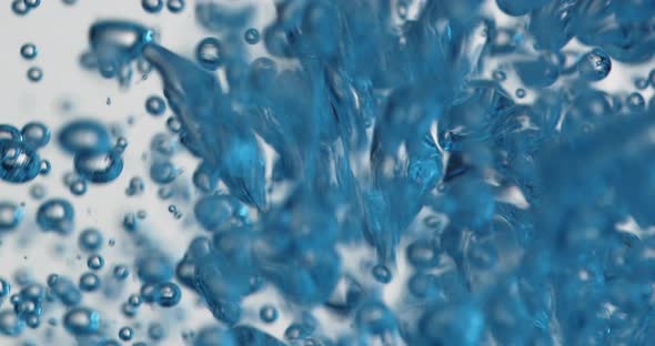 Blue Bubbles Rising In Water As Liquid Is Poured alt