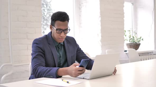 Businessman Shocked By Result on Smartphone Wondering alt