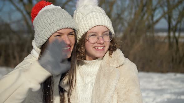 Young Woman and Her Teenage Daughter are Having Fun on a Winter Walk