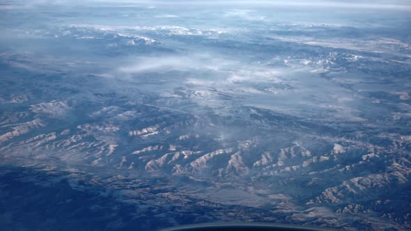 View From Porthole of Snow Capped Mountains