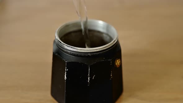 Water Pours From a Filter Jug Into a Geyser Coffee Maker Light Background The Process of Making