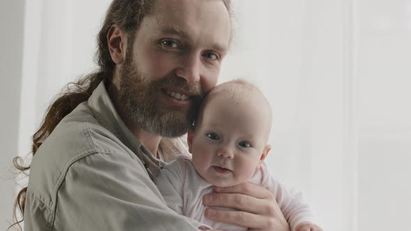 Family Portrait Smiling Caucasian Bearded Dad Father Man Holding Hugging Small Infant Newborn Girl alt