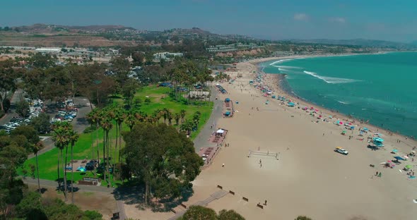 DANA POINT, California. Doheny State Beach. A Sunny Day Beach Scene with People Engaged in Beach alt