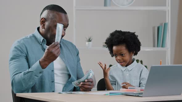 Cheerful Adult Father and Little Cute Daughter Sitting at Home Dad Teaches Kid Girl to Count Shows alt