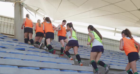 Female hockey players warming up in stands alt