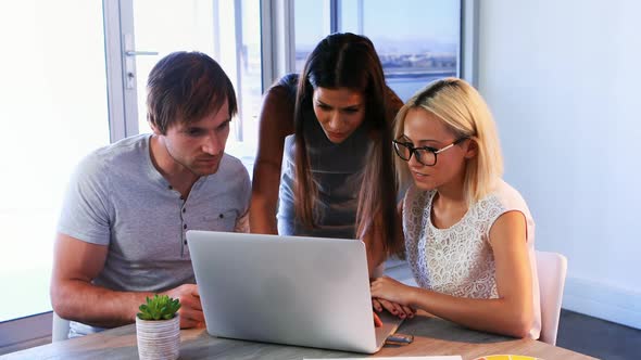 Executives discussing over laptop during a meeting 4k alt