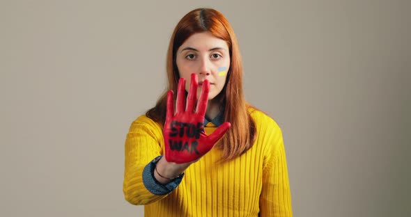 Girl Raises Her Red Hand with Stop War to Stop the Horrors in Ukraine alt