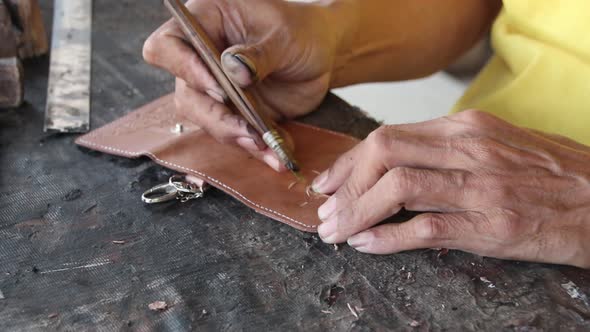  craftsman when carving leather for decoration