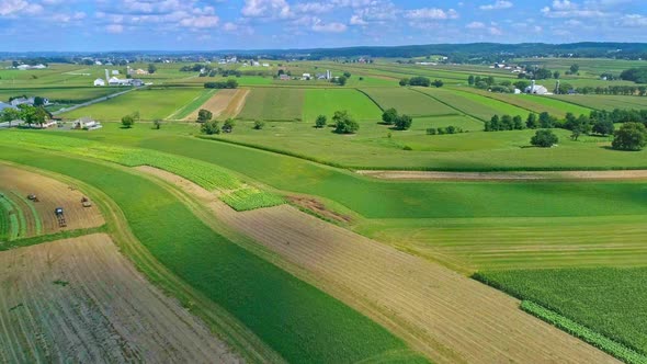 Aerial Traveling View of Corn Fields and Harvesting Crops, with Patches of Color
