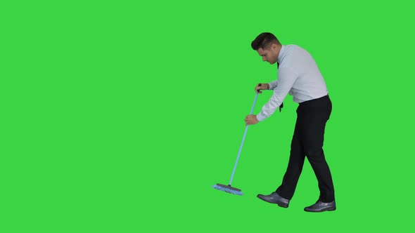 Man in Official Clother Sweeping the Floor on a Green Screen, Chroma Key alt