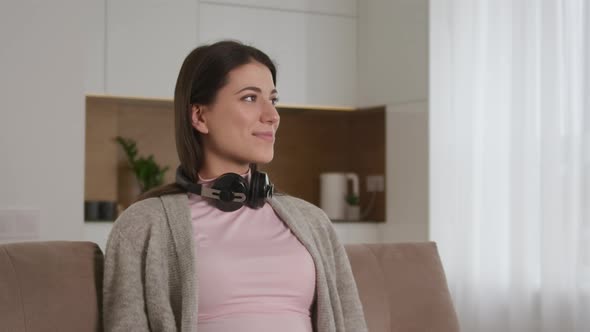 Portrait of a Young Caucasian Woman Looking Sideways Turning to the Camera and Smiling with alt